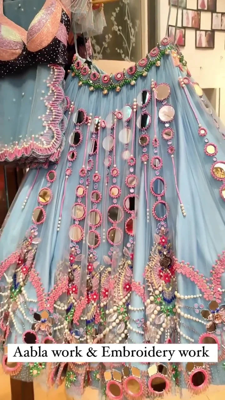 Exquisite Sky Blue Net Lehenga Choli with Heavy Aabla Mirror Work, Pink Thread Embroidery, and Intricate Pearl and Bead Detailing