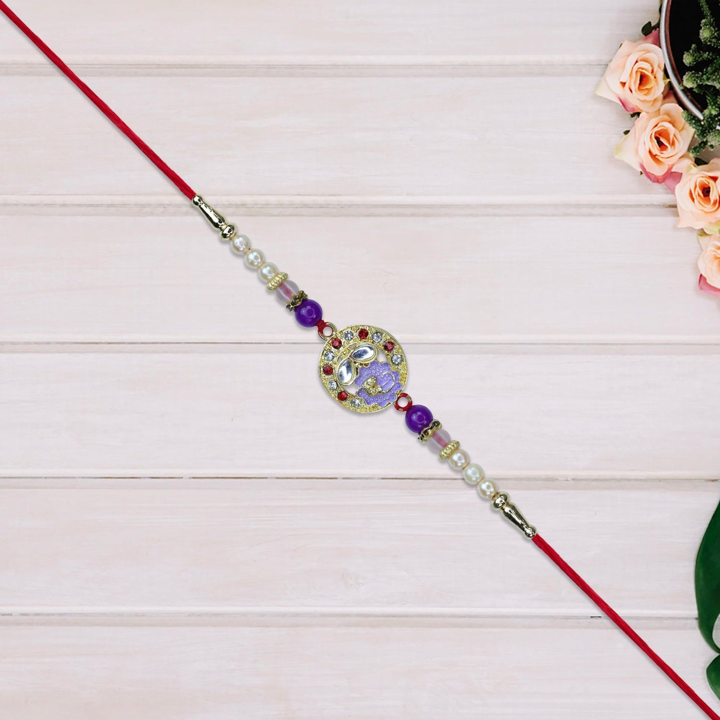 Elegant Ganesh Rakhi with Pearl and Purple Beads