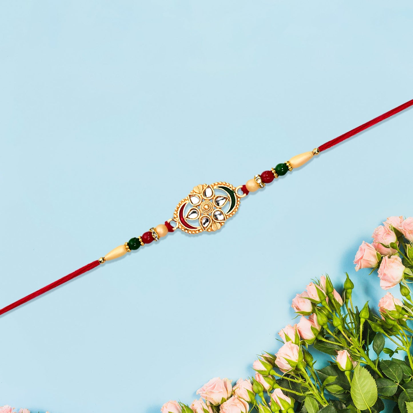 Traditional Oval Rakhi with Kundan Work and Red-Green Beads