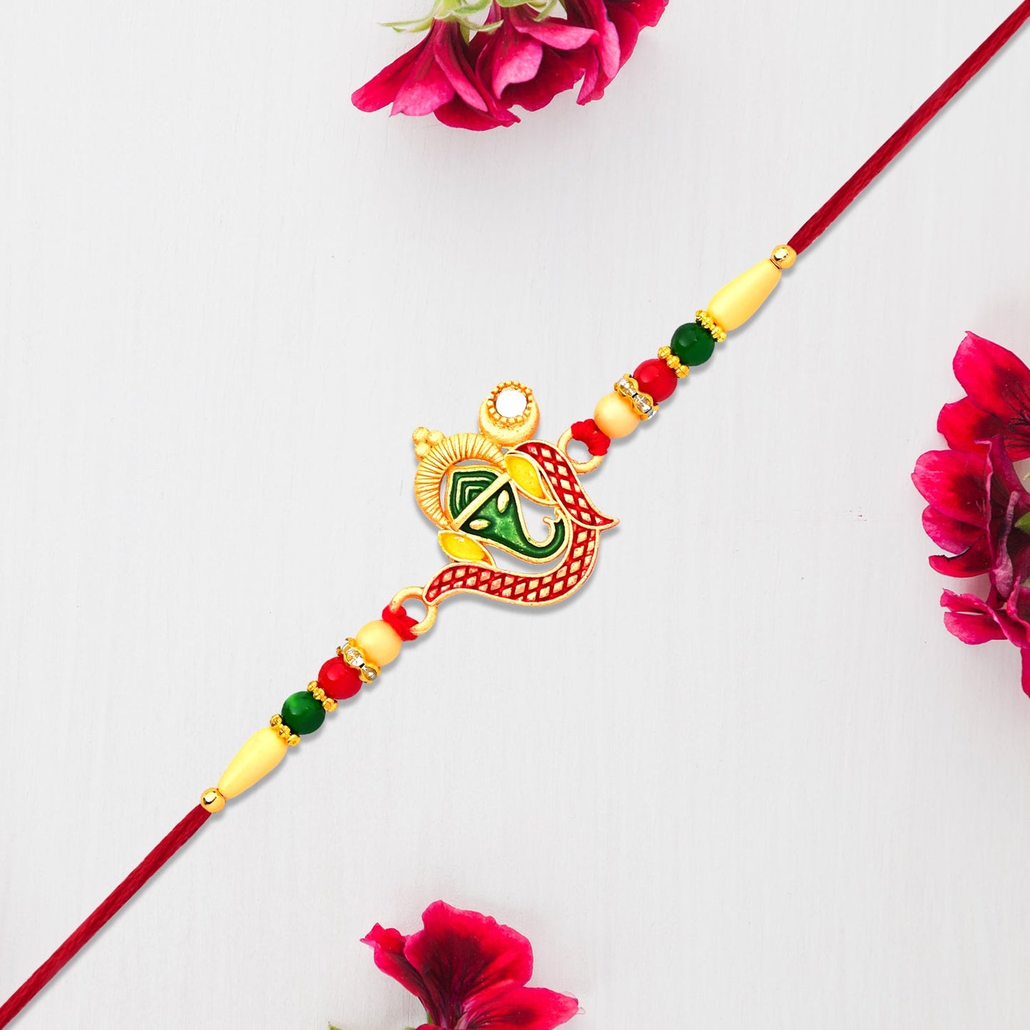 Green Enamel Lord Ganesha Rakhi with Decorative Red Thread and Golden Accents