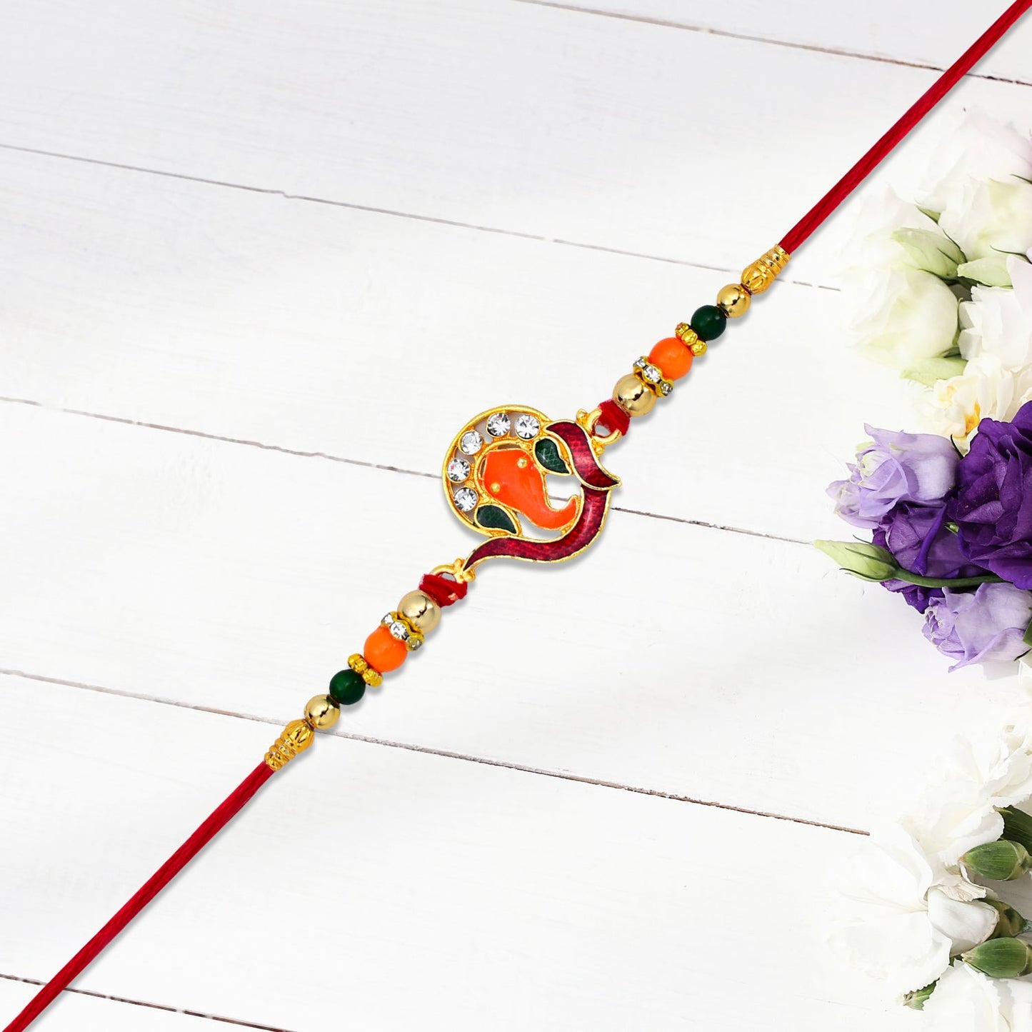 Golden Ganesha Rakhi with Red-Green Beads and Stone Detailing