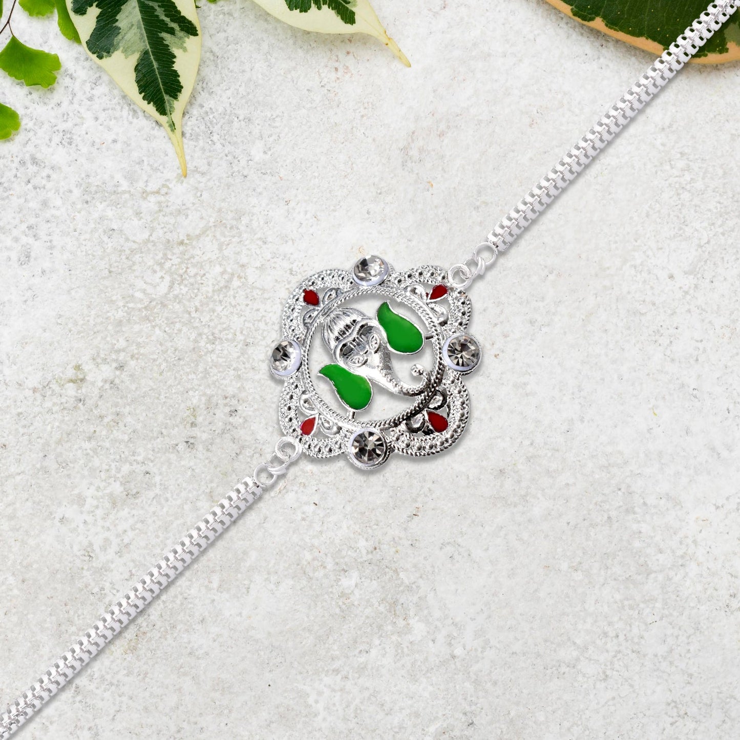 Silver Ganesha Rakhi with Green Leaf Accent