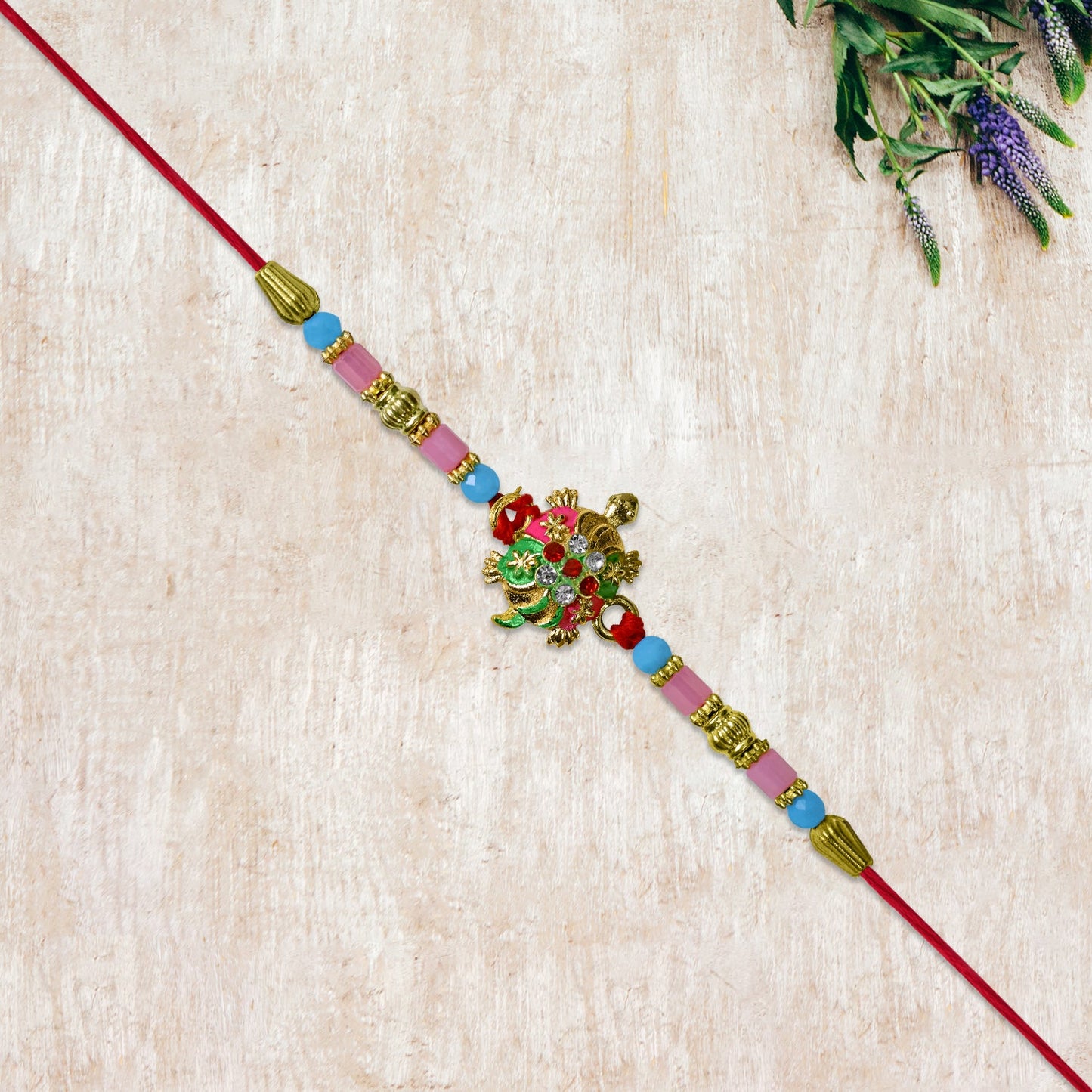 Turtle Design Rakhi with Floral Accents and Beads