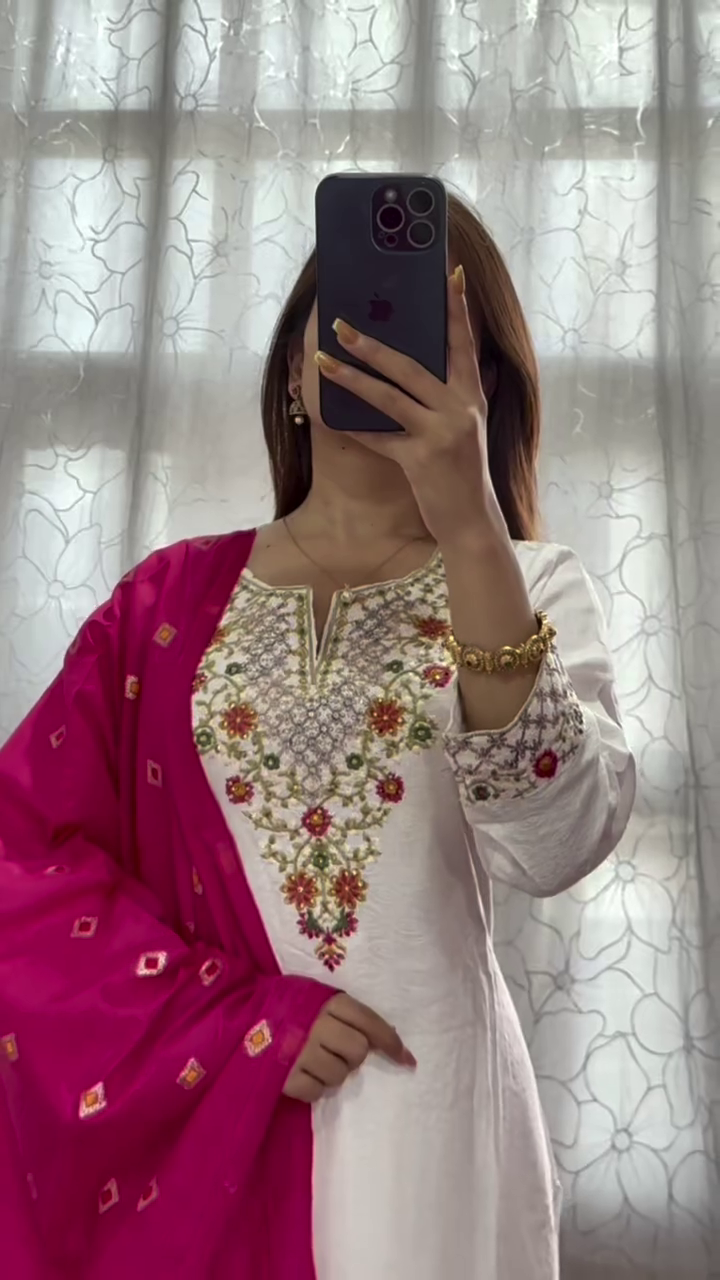 Elegantly Draped in a Traditional White Embroidered Kurta with a Vibrant Magenta Dupatta, Showcasing Intricate Floral and Geometric Designs for a Stylish Ethnic Look