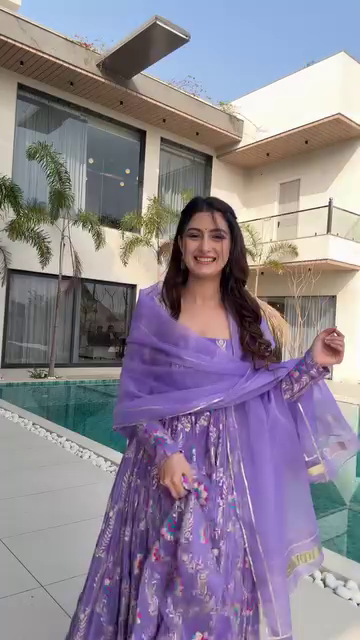 Lavender Floral Printed Anarkali Dress with Sheer Long Sleeves and Flowing Skirt, Perfect for Daytime Events, Weddings, and Festive Celebrations, Styled with a Graceful Vibe by the Poolside.