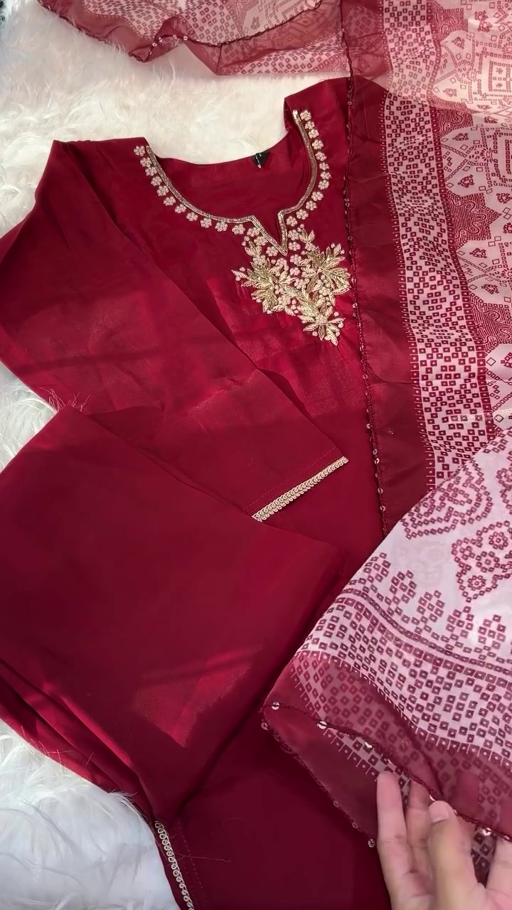 A vibrant red dress with delicate gold embroidery around the neckline, paired with a sheer matching dupatta featuring intricate patterns, making it a perfect choice for festive or traditional occasions.