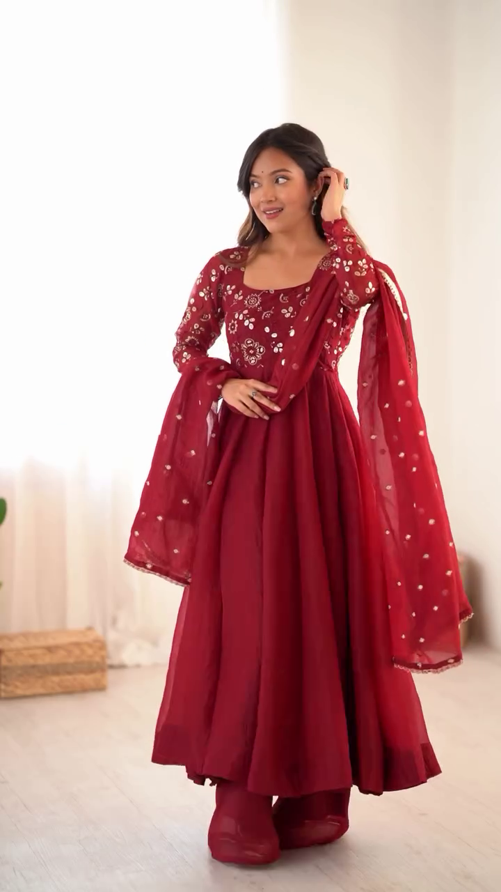 Stunning Maroon Anarkali Kurta Set Heavily Embellished Mirror and Thread Work Paired with a Flared Gown-Style, Matching Palazzo Pants, and Net Dupatta with Gold Sequin Butis and Border – Perfect for Weddings, Festive Events