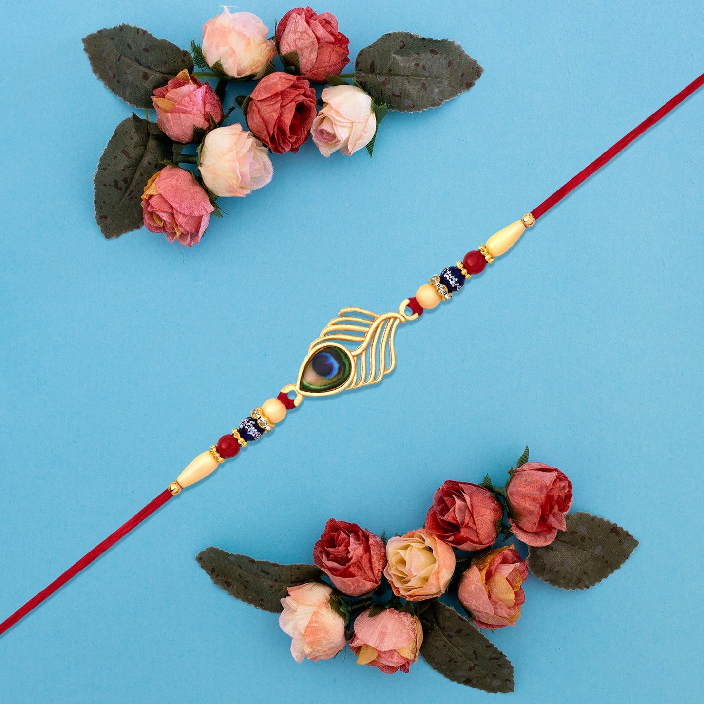 Peacock Feather Design Rakhi with Beaded Detailing and Red Thread