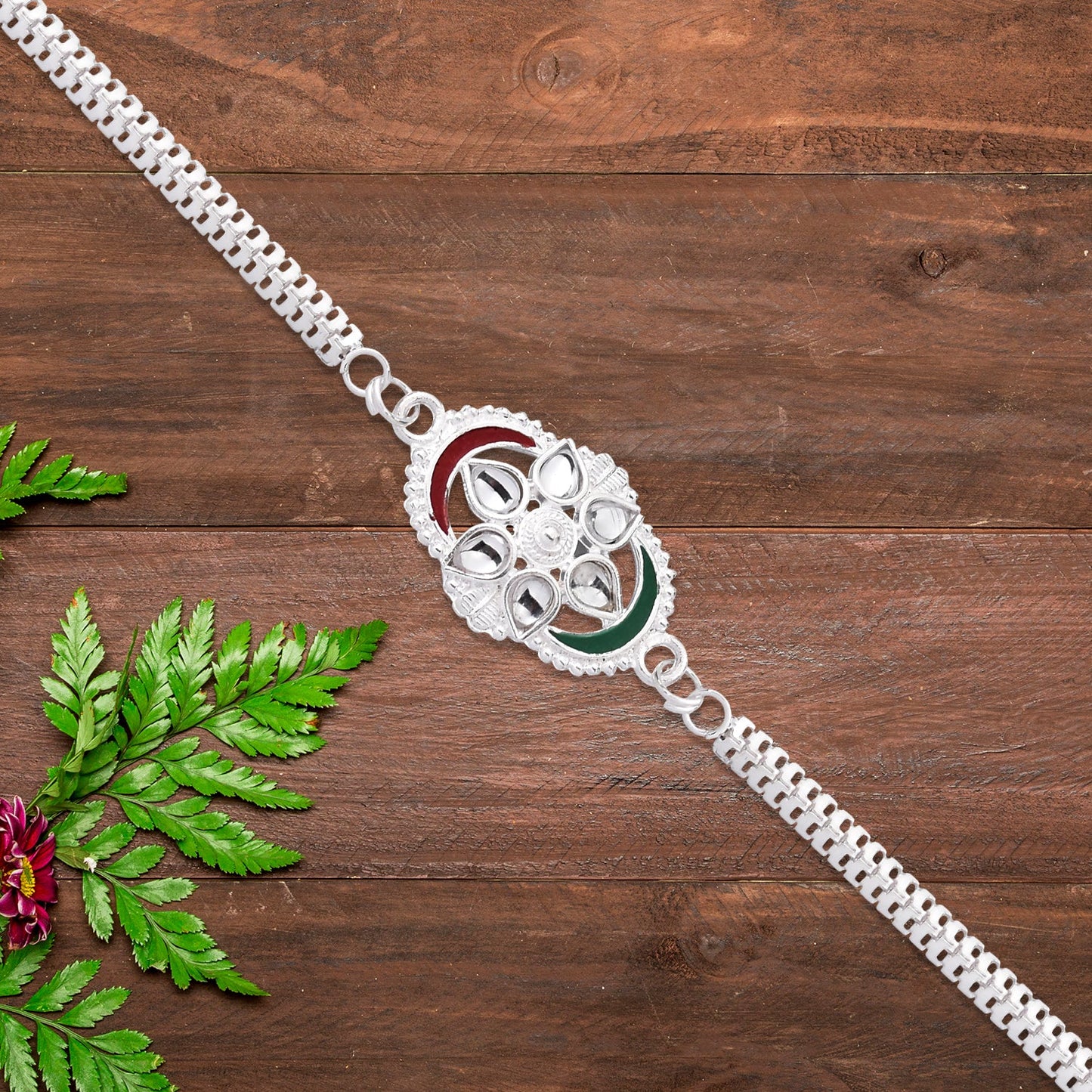 Silver Chain Rakhi with Sparkling Stones and Elegant Red-Green Detailing