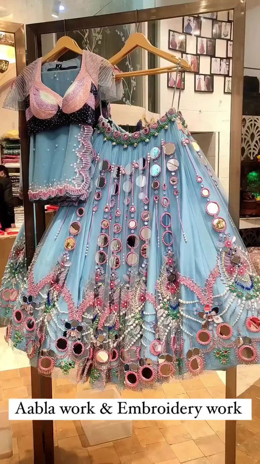 Exquisite Sky Blue Net Lehenga Choli with Heavy Aabla Mirror Work, Pink Thread Embroidery, and Intricate Pearl and Bead Detailing