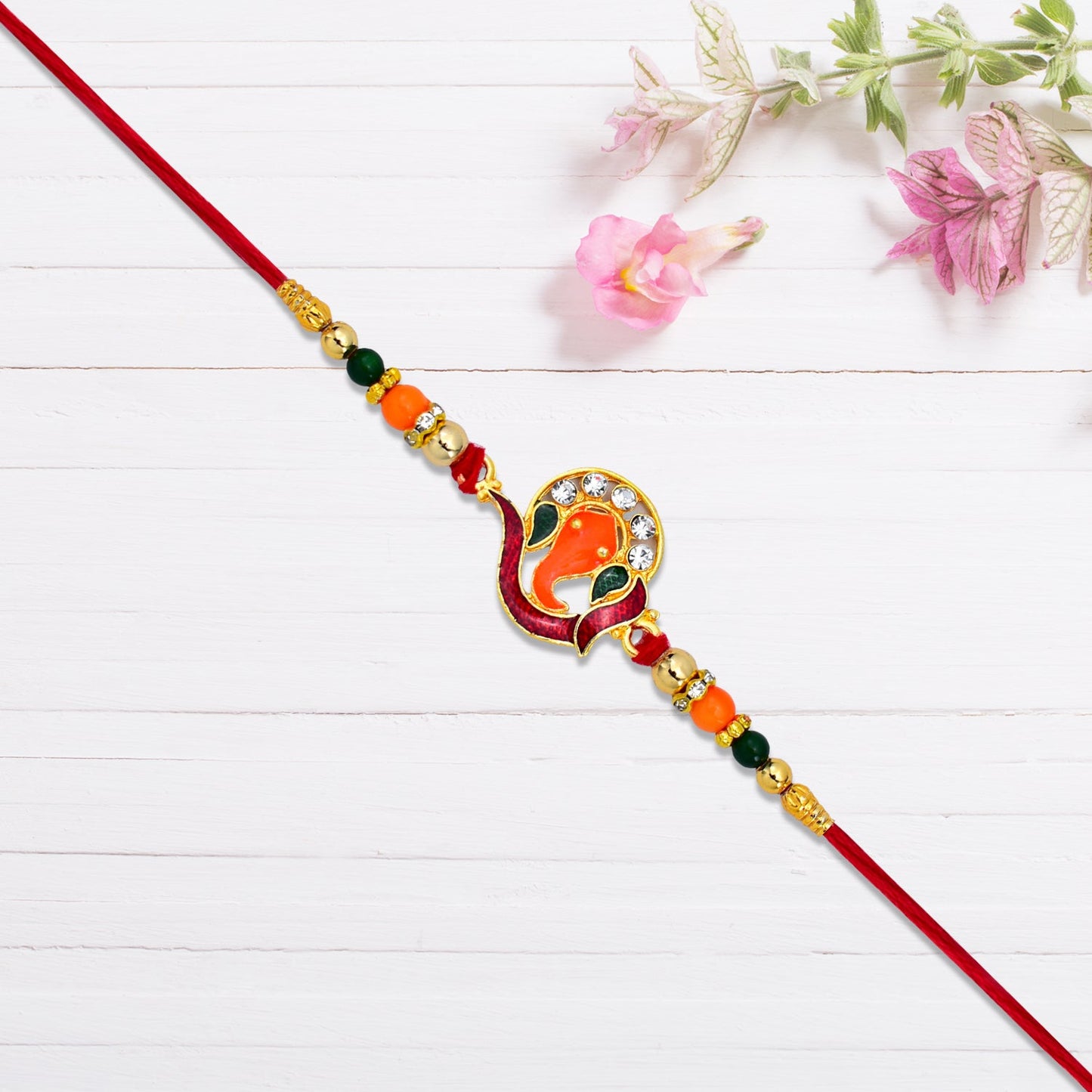 Golden Ganesha Rakhi with Red-Green Beads and Stone Detailing