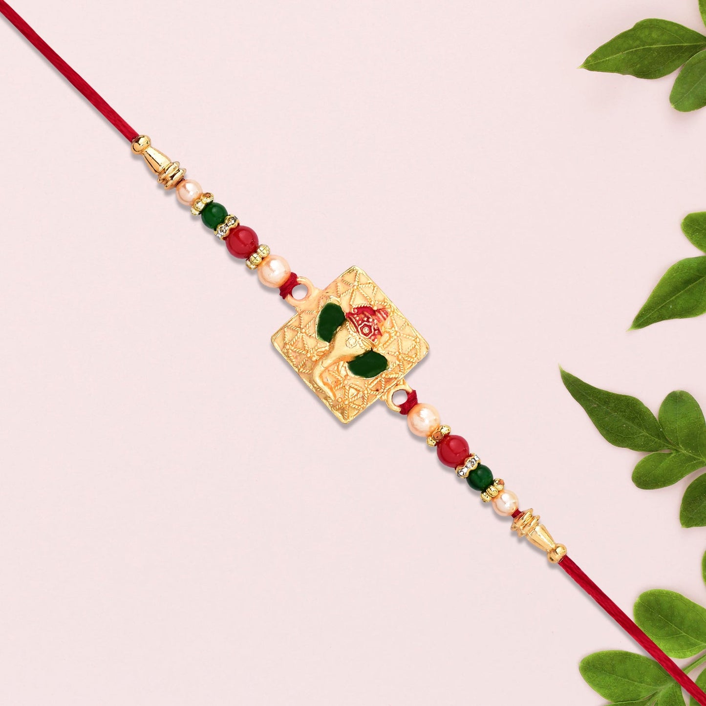 Golden Ganpati Rakhi with Red-Green Beads and Enamel Detailing