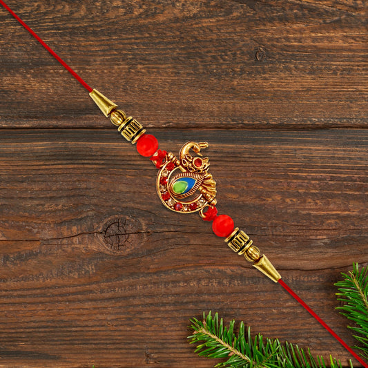 Golden Peacock Rakhi with Red Beads