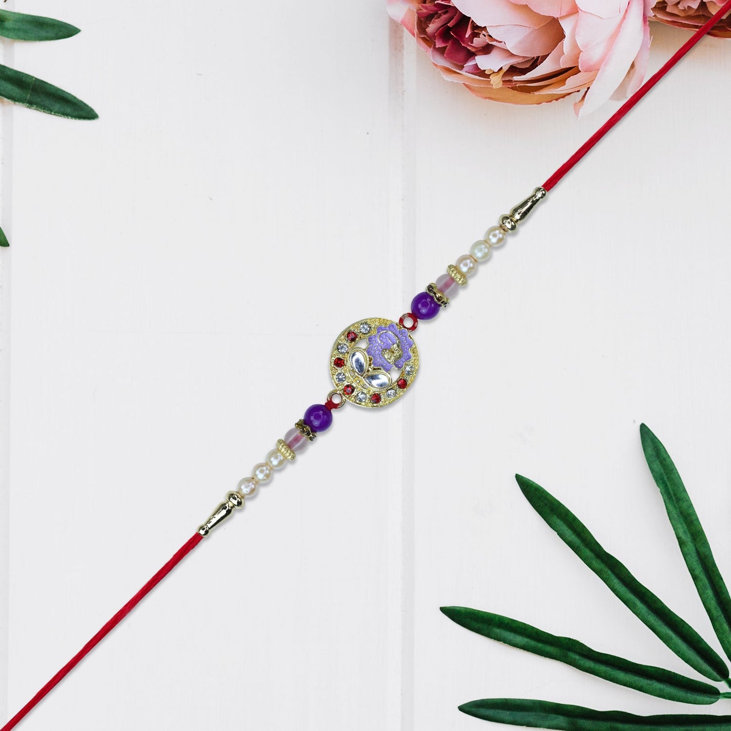 Elegant Ganesh Rakhi with Pearl and Purple Beads