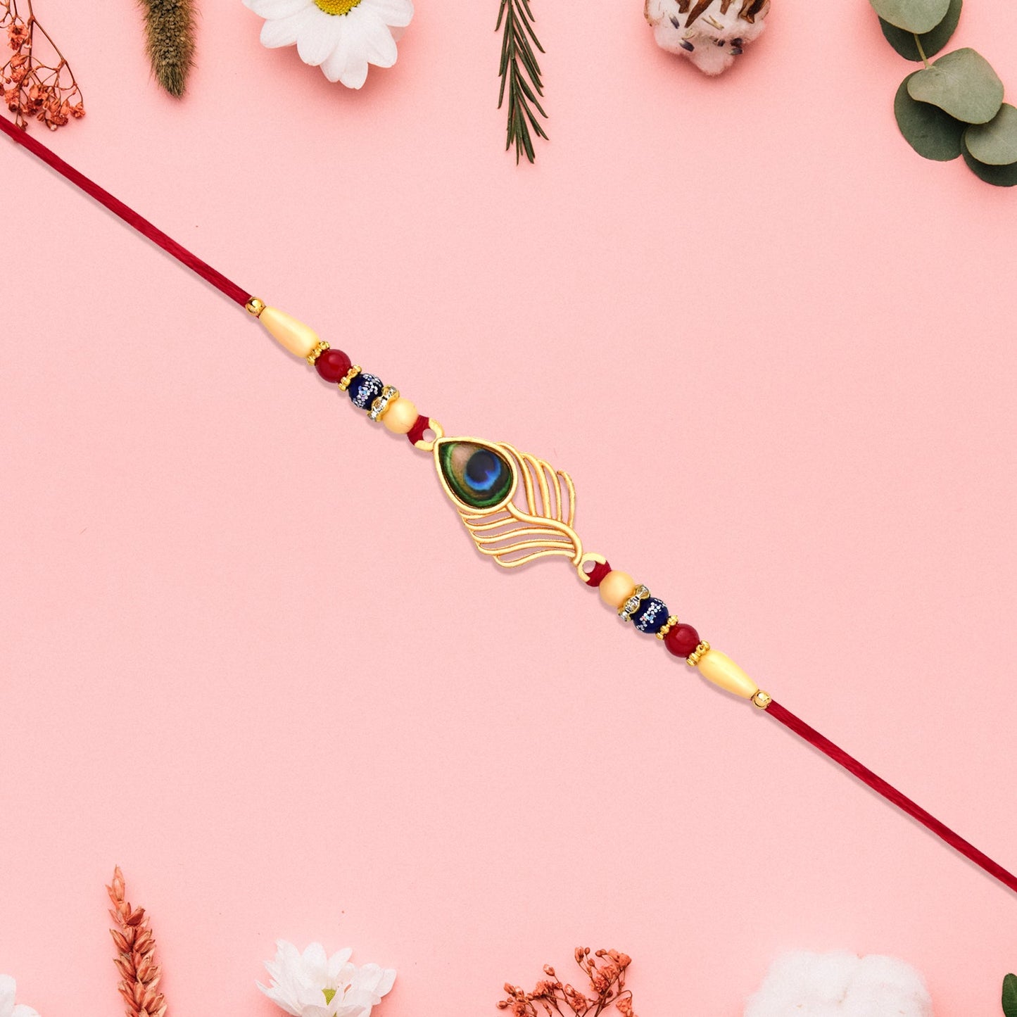 Peacock Feather Design Rakhi with Beaded Detailing and Red Thread