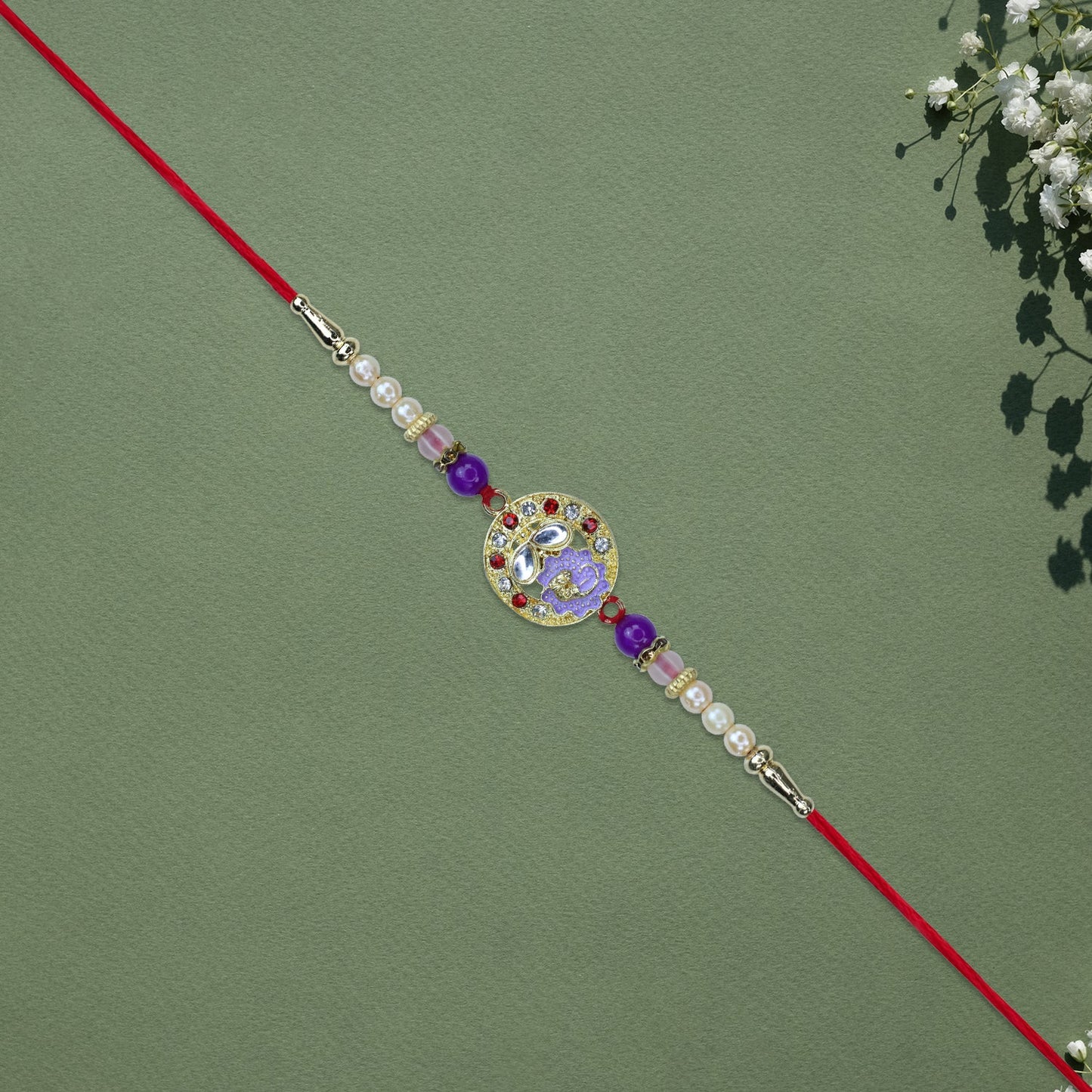 Elegant Ganesh Rakhi with Pearl and Purple Beads