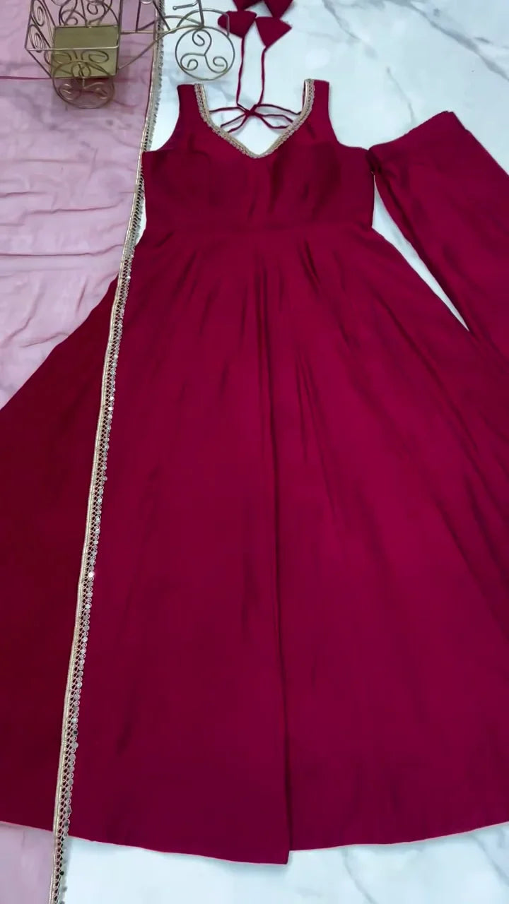 Deep Maroon Full-Flare Anarkali Gown Featuring a Sleeveless Design, Sparkling Metallic Scalloped Neckline Trim, Back Dori Tie-Up Detail, and a Dazzling Side-Seam Embellished Border