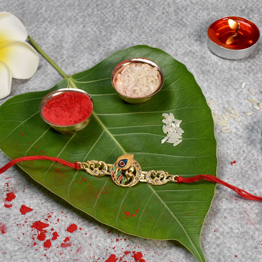 Golden Krishna Flute Rakhi with Colorful Enamel and Red Thread