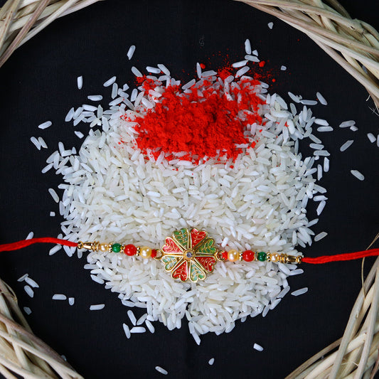 Traditional Rakhi with Bright Floral Centerpiece and Decorative Thread
