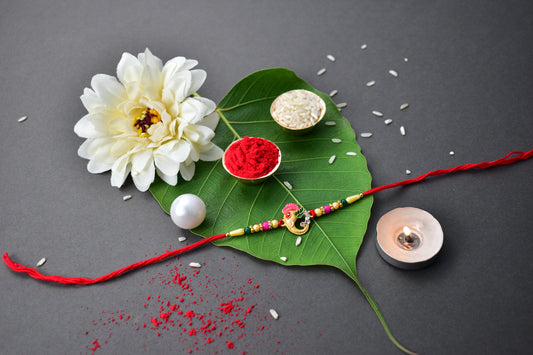 Stylish Ganesh Design Rakhi with Multicolor Beads and Gold Finish Accents