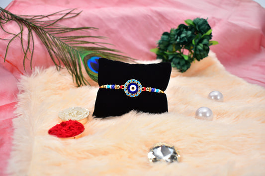 Evil Eye Rakhi with Blue Beads and Golden Accents – Protective Nazar Design