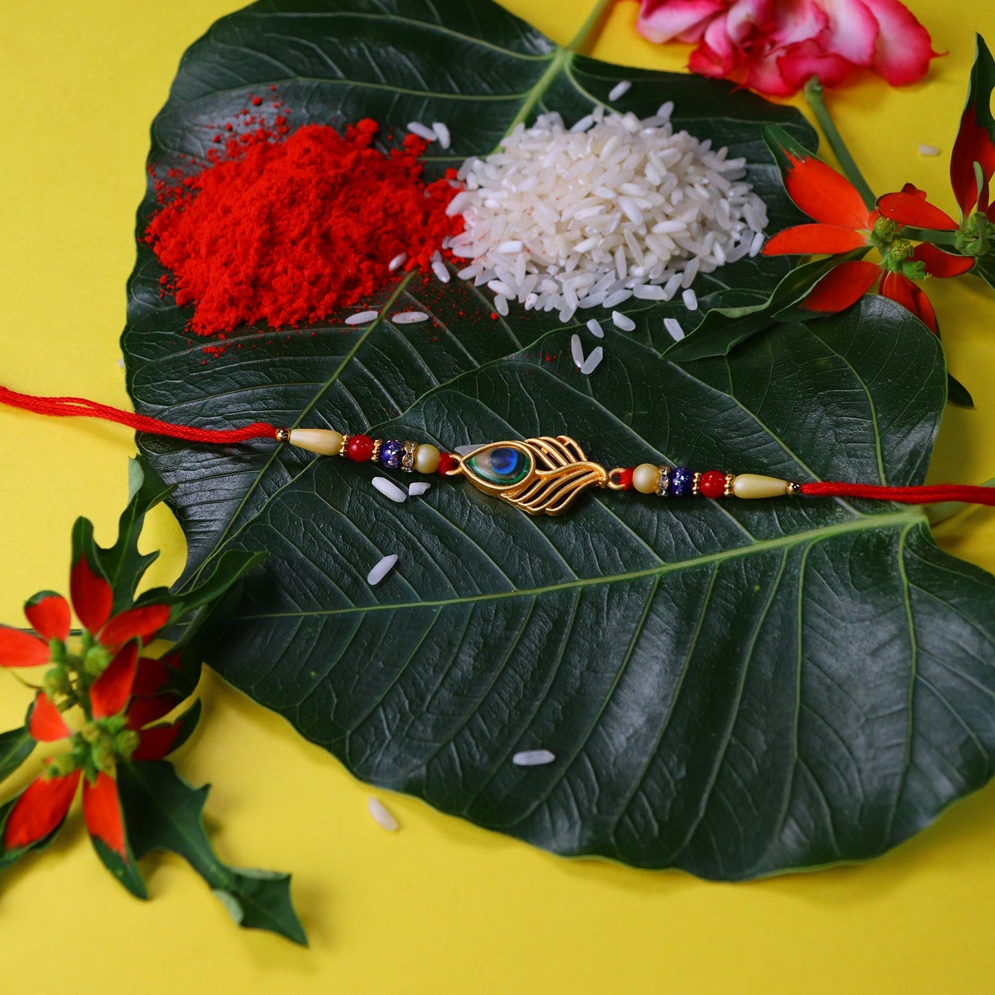 Peacock Feather Design Rakhi with Beaded Detailing and Red Thread