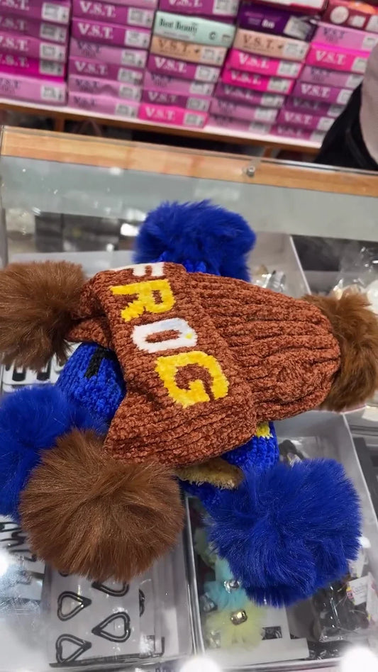 Cozy Knit Winter Hat Collection Featuring "FROG" Lettering, Dual Oversized Faux Fur Pom-Poms, and a Cuffed Design, Available in Multiple Vibrant Colors including Red/Black and Brown/Blue