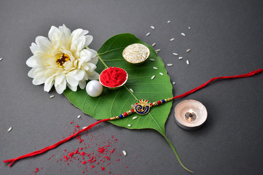 Peacock-Themed Designer Rakhi with Colorful Beads – Blue, Red & Gold Finish