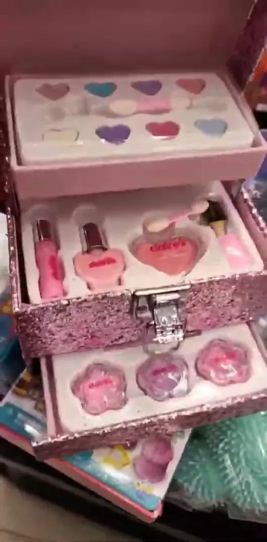Glittery Pink Makeup Trunk: Multi-Tiered Cosmetic Set with Heart-Shaped Glosses, Pink Nail Polish, and Flower-Shaped Blushes