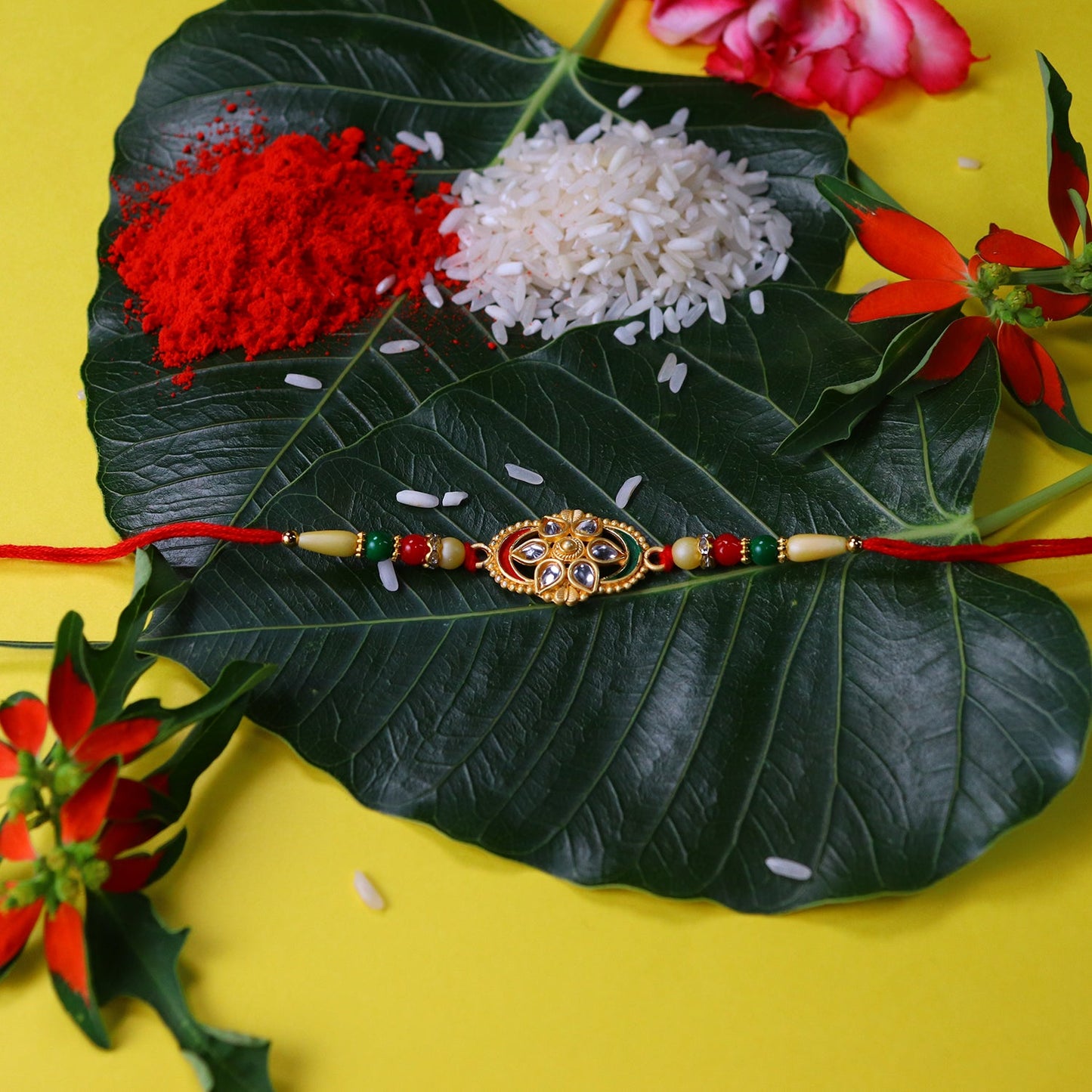 Traditional Oval Rakhi with Kundan Work and Red-Green Beads