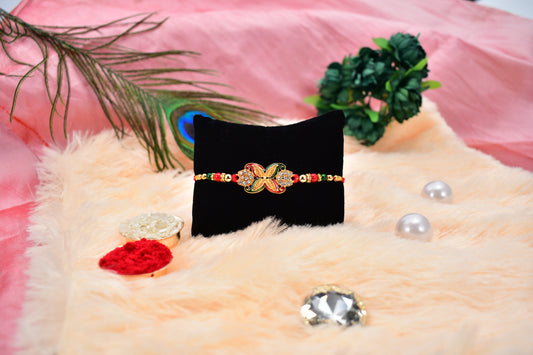 Elegant Red-Green Bead Rakhi with Intricate Golden Flower Motif