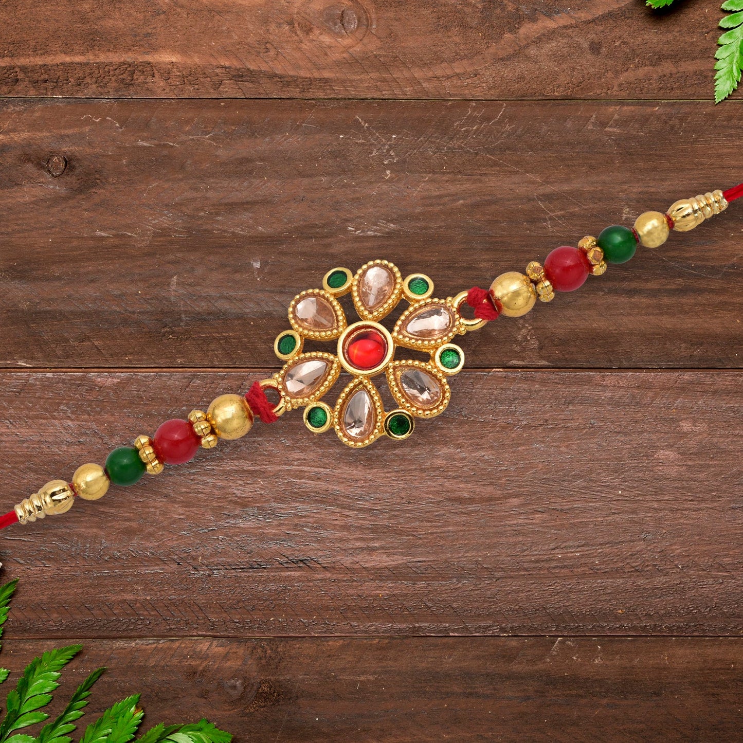Floral Kundan Rakhi with Red-Green Beads and Golden Finish