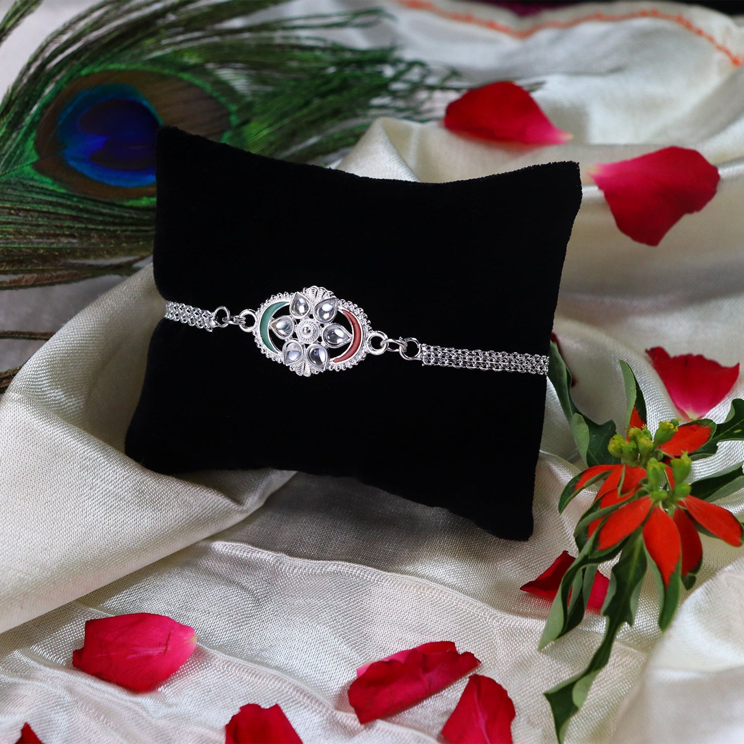 Silver Chain Rakhi with Sparkling Stones and Elegant Red-Green Detailing
