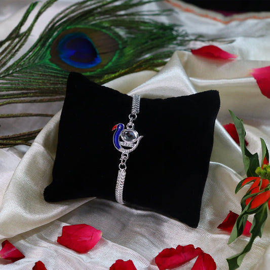 Elegant Peacock Design Rakhi with Blue Enamel and Silver Metal Chain