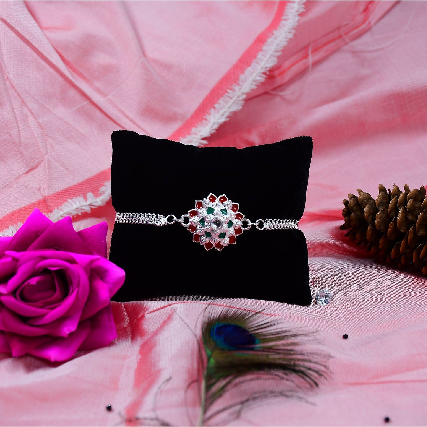 Traditional Floral Rakhi with Red & Green Stones – Silver Designer Rakhi for Brother