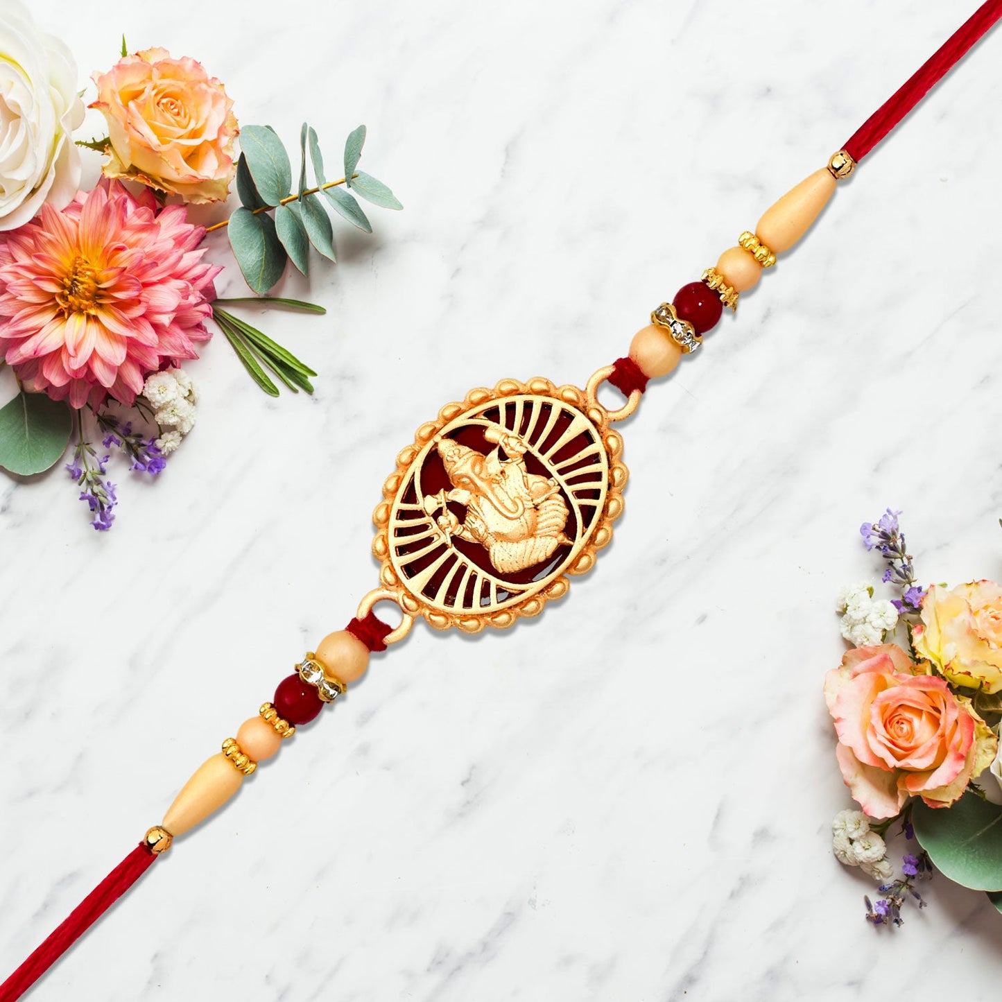 Traditional Ganesha Rakhi with Golden Finish and Sacred Red Thread