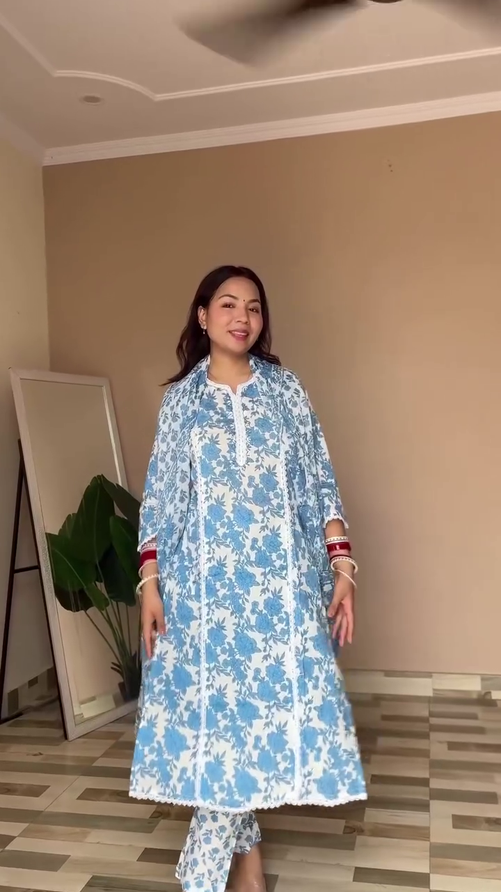 A charming blue and white floral ethnic outfit with a delicate kurta, matching dupatta, and pants, paired with traditional bangles, perfect for a relaxed yet elegant look.
