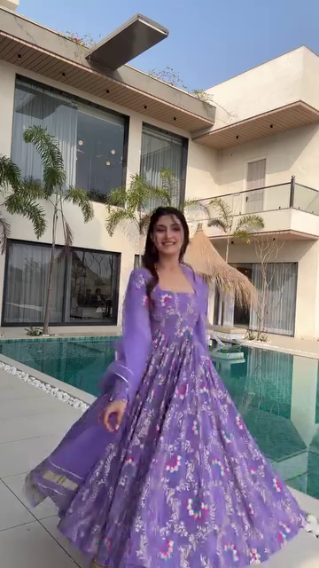 Lavender Floral Printed Anarkali Dress with Sheer Long Sleeves and Flowing Skirt, Perfect for Daytime Events, Weddings, and Festive Celebrations, Styled with a Graceful Vibe by the Poolside.