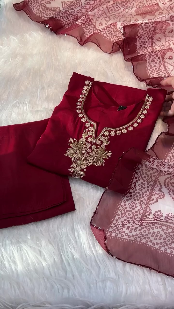 A vibrant red dress with delicate gold embroidery around the neckline, paired with a sheer matching dupatta featuring intricate patterns, making it a perfect choice for festive or traditional occasions.