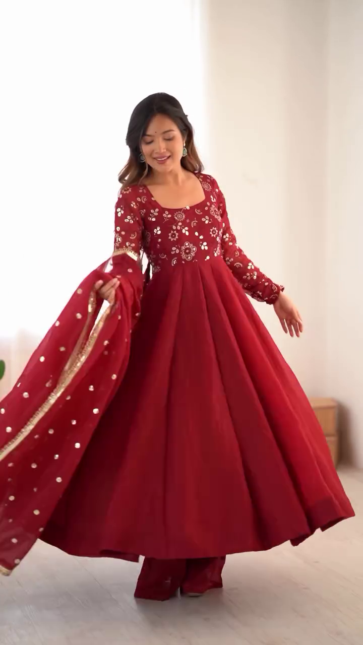 Stunning Maroon Anarkali Kurta Set Heavily Embellished Mirror and Thread Work Paired with a Flared Gown-Style, Matching Palazzo Pants, and Net Dupatta with Gold Sequin Butis and Border – Perfect for Weddings, Festive Events