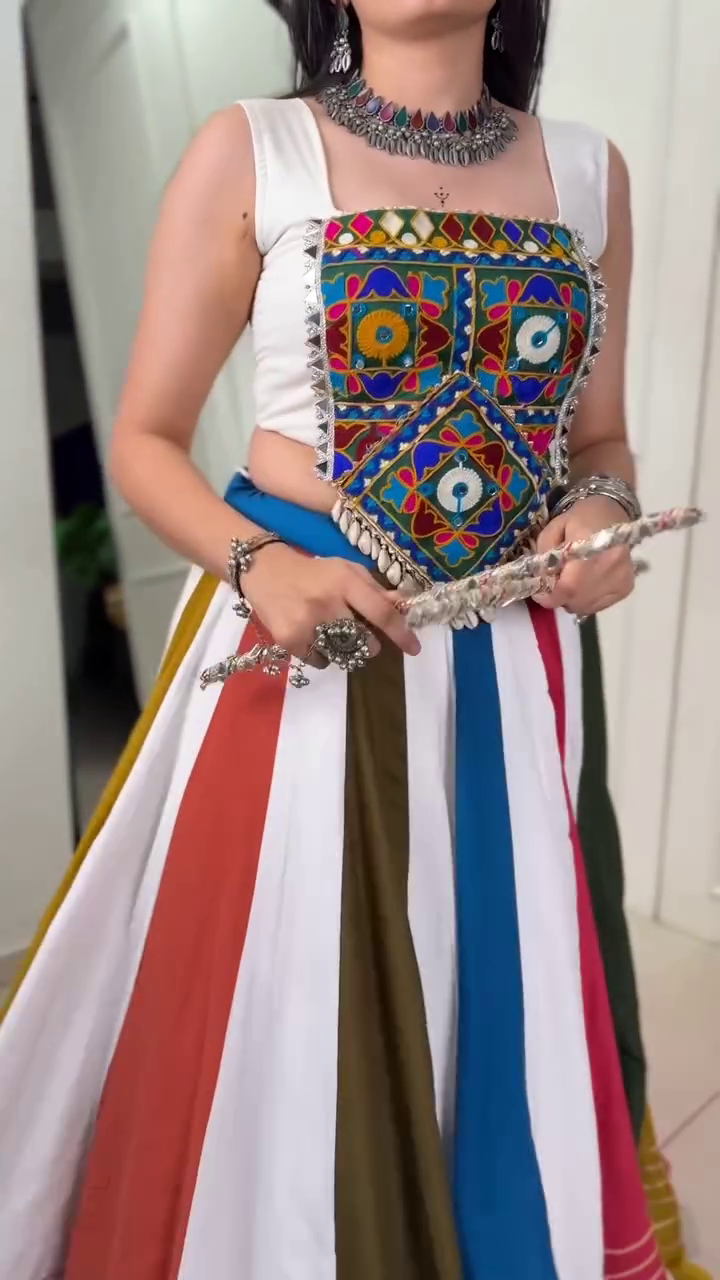 Multicolor Panelled Lehenga Set Featuring a Mirror-Embroidered Sleeveless Blouse with Traditional Kutchi Work and Flared Striped Skirt – A Festive and Boho-Chic Ensemble for Navratri, Garba Nights, and Cultural Celebrations
