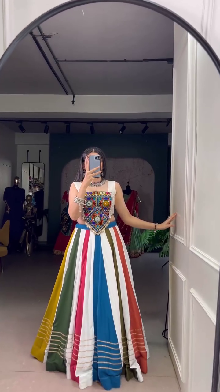 Multicolor Panelled Lehenga Set Featuring a Mirror-Embroidered Sleeveless Blouse with Traditional Kutchi Work and Flared Striped Skirt – A Festive and Boho-Chic Ensemble for Navratri, Garba Nights, and Cultural Celebrations